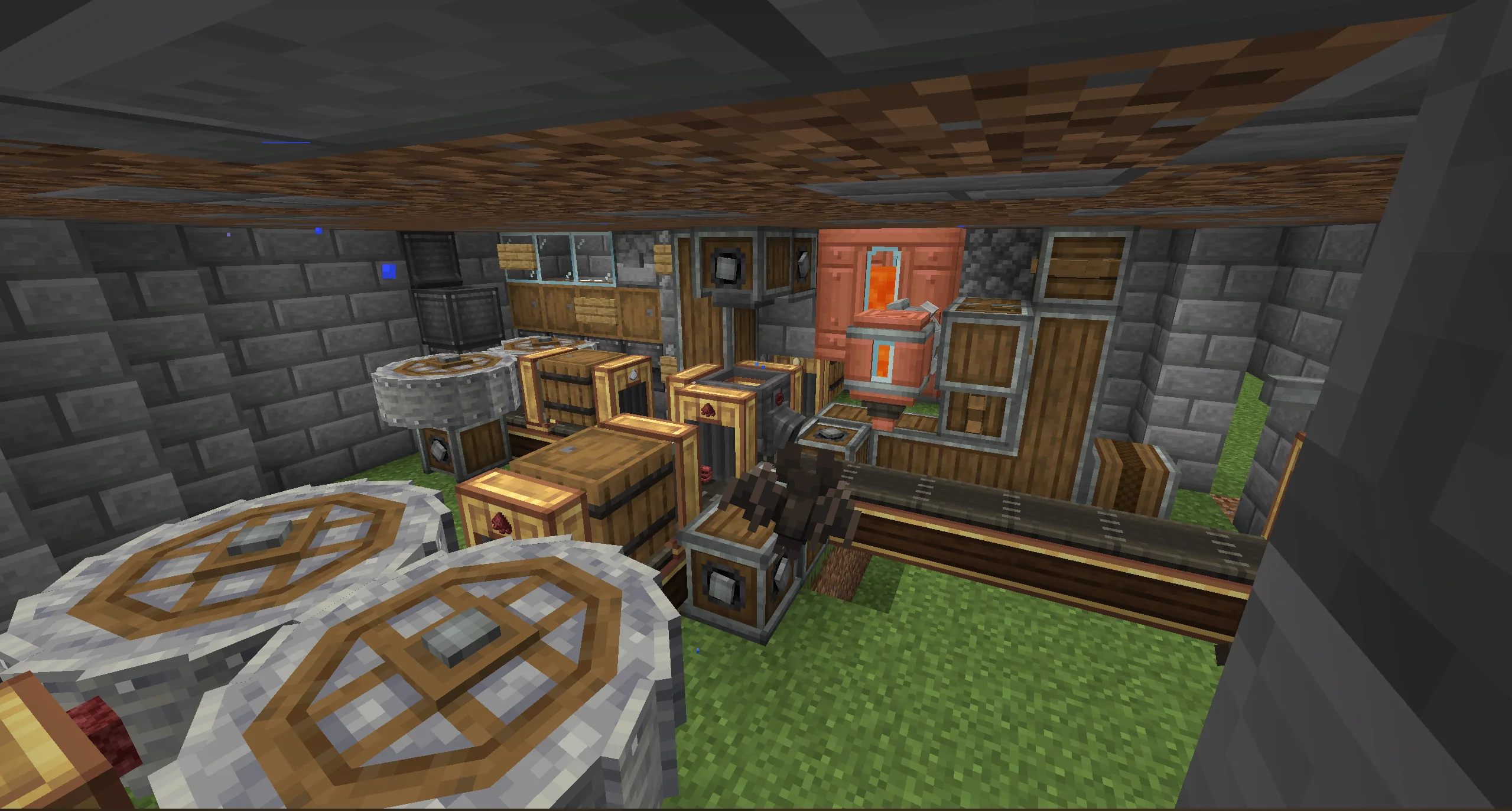 Blaze Cake Farm W with a compact stone-brick frame, dirt and sugar cane area, belts, gearboxes, barrels, and brass funnels.